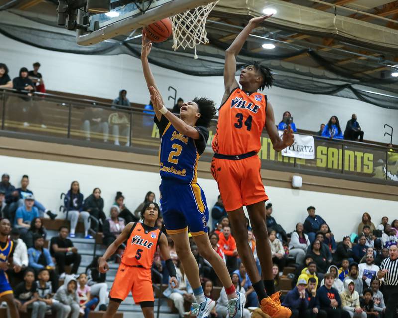 Romeoville's Adam Walker (34) goes up the pin a lay up attempt by Joliet Central's Zion Kostyra (2) in the WJOL Tournament Championship game. Nov 25, 2023.