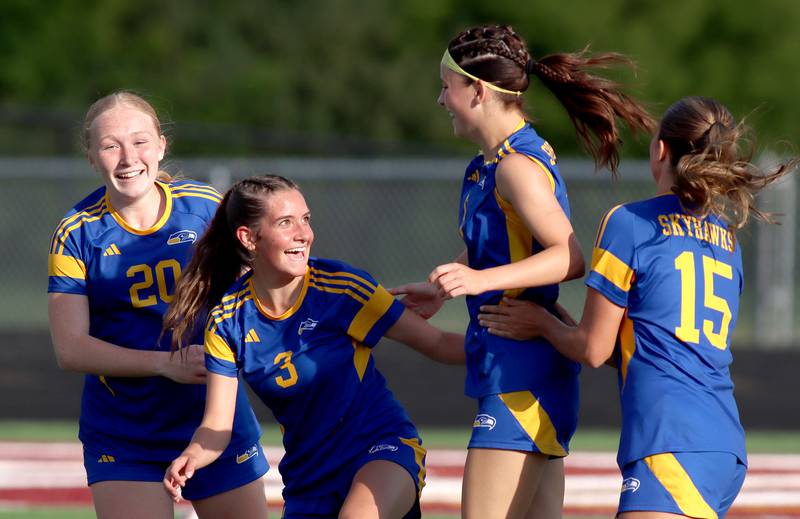 Johnsburg’s Liz Smith, second from right, is greeted by, from left, Kayla Hiller, Charlie Eastland and Lauren McQuiston after a Smith goal against North Shore Country Day  in IHSA Class 1A Sectional Title Game action at Richmond-Burton High School in Richmond on Tuesday, May 27, 2025.
