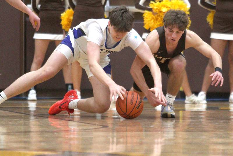 Jacobs’  Ben Jurzak, right, races Lake Zurich’s Anton Strelnikov for the ball in Hinkle Holiday Classic boys basketball tournament game action at Jacobs High School Tuesday.