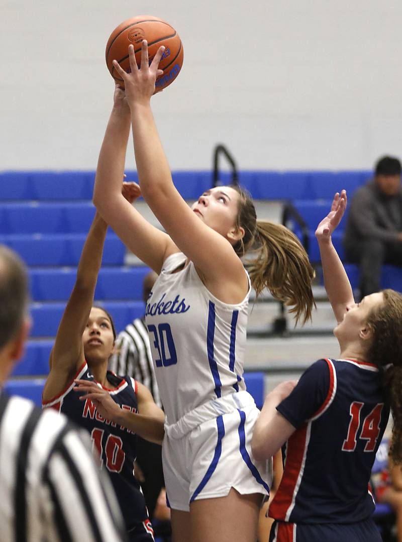 Burlington Central's Emma Payton shoots the ball between Belvidere North’s Haylee Gallas and Camryn Diercks Monday, Nov. 13, 2023, during pool play girls basketball game in the Burlington Central Mark Einwich Tournament.