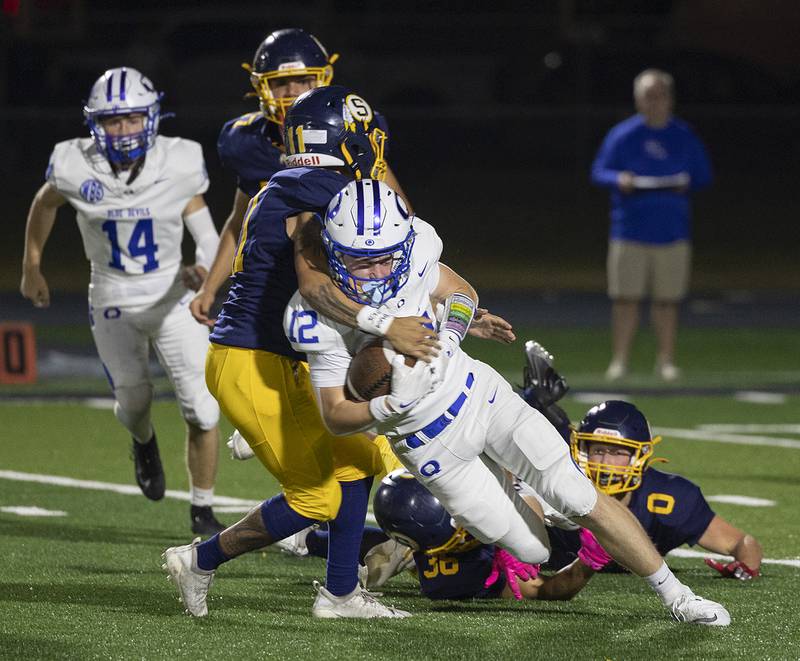 Sterling’s Vitor Polo gets his arms around Quincy’s Sawyer Harshberger Friday, Oct. 17, 2025.