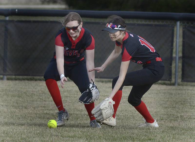 Hall’s Mya McLaughlin (left) and Haven Rossi converge in right-center field to scoop up a WFC single in the third inning of their season opener Tuesday, March 12, 2024, in rural Streator.