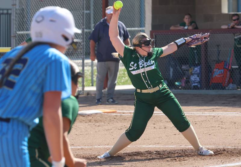 St. Bede pitcher Macy Strauch lets go of a pitch as Marquette's Kelsey Cuchra eyes home plate on Tuesday, April 23, 2026 at June Cross Field in Ottawa.