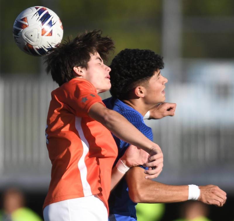 John Starks/jstarks@dailyherald.com
St. Charles East’s Ryan Vandeveer and St. Charles North’s Walter DelaPaz, right, compete for a header in the TriCities boys soccer night game in Geneva on Tuesday, September 27, 2022.
