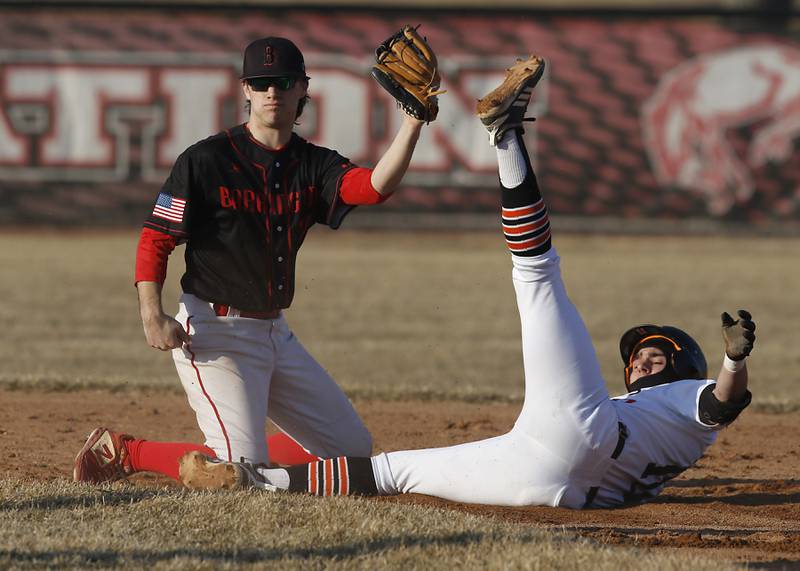 Barrington’s JD Swarbrick holds up the ball after taking out Crystal Lake Central’s Niko Acevado as Acevado tries to stretch and hit into a double during a non-conference baseball game Tuesday, March 15, 2022, between Crystal Lake Central and Barrington at Barrington High School.