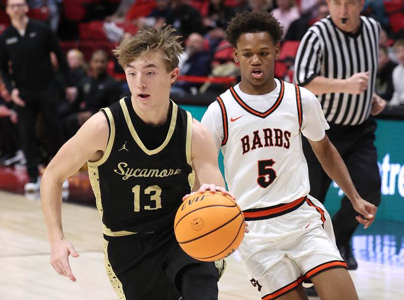 Sycamore's Xander Lewis goes to the basket ahead of DeKalb's Bryan Miller Friday, Jan. 30, 2026, during the FNBO Challenge at the Convocation Center at Northern Illinois University in DeKalb.