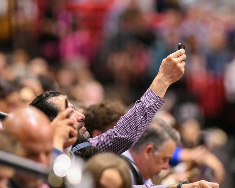 Friends and family capture special moments for their graduates at the 2024 DeKalb High School commencement ceremony on Saturday, May 25, 2024, at the Northern Illinois University Convocation Center in DeKalb.