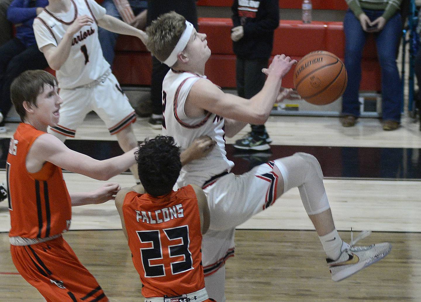 Woodland’s Jonathan Moore (2) is fouled driving to the hole while being defended by Flanagan-Cornell’s Logan Ruddy and Rudra Patel (23) on Wednesday, Feb. 15, 2023, at Woodland School.