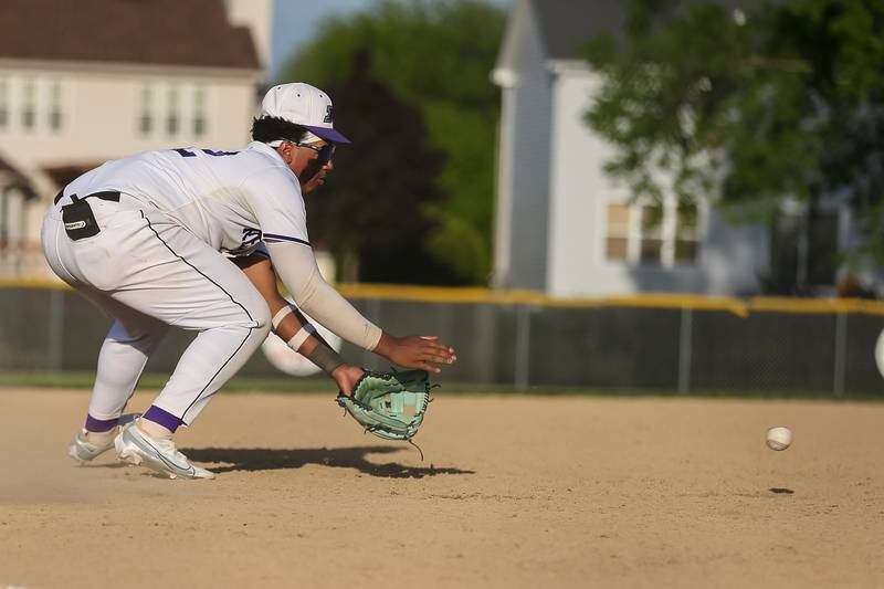 Plano's Jason Phillips (42) fields a grounder at third during baseball game between Sandwich at Plano.  May 8, 2024
