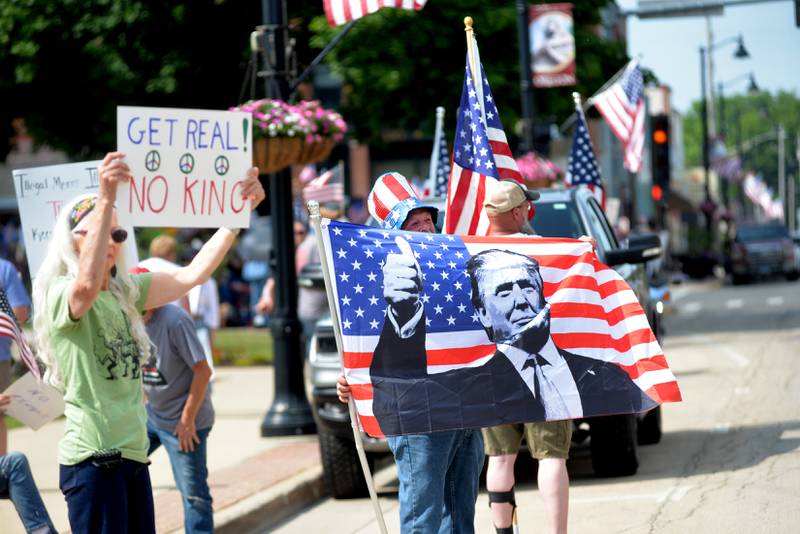 Signs critical and in support of President Donald Trump were on display during a rally in Oregon, Illinois on Saturday, June 14, 2025.