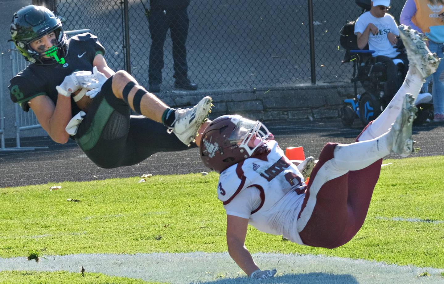 Glenbard West's Filip Maciorowski (left) makes an acrobatic touchdown catch behind Lockport defender Joey Manzo (3) during an IHSA Class 8A playoff game on Oct. 29, 2022 at Glenbard West High School in Glen Ellyn.