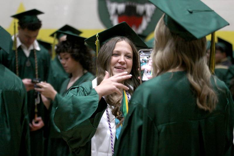 Kaylynn Attanaseo performs for a TikTok video as she lines up for graduation at Crystal Lake South High School in Crystal lake on Saturday, May 17, 2025.