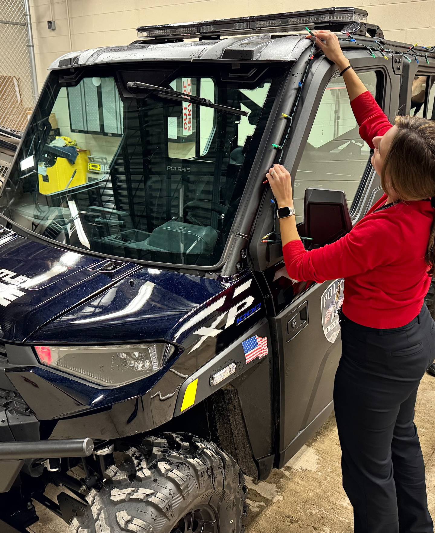 Carly Ritter from the Huntley Police Department decorates department vehicles Wednesday, Dec. 3, 2025, for Saturday's Christmas parade, a newly added part of the Very Merry Huntley holiday celebration. The parade steps off at 5 p.m. Saturday at the intersection of Main and Bakley streets.