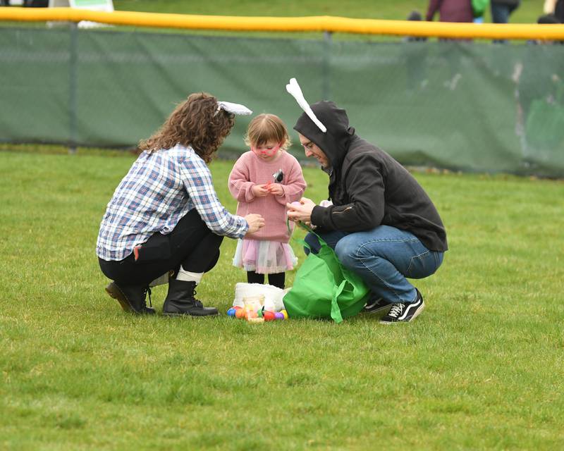 Madlin Gleich, 2, of Elmhurst checks out her goodies from the Easter eggs she collected along with her parents Ashley Goodman and Tim Gleich on Saturday April 19, 2025, held at Berens Park in Elmhurst.
