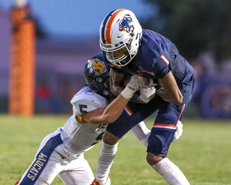 Oswego's Jeremiah Cain (1) is tackled after a reception during a football game between Neuqua Valley and Oswego on Friday, Aug. 30, 2024 in Oswego. Gary E Duncan Sr for Shaw Local News Network.