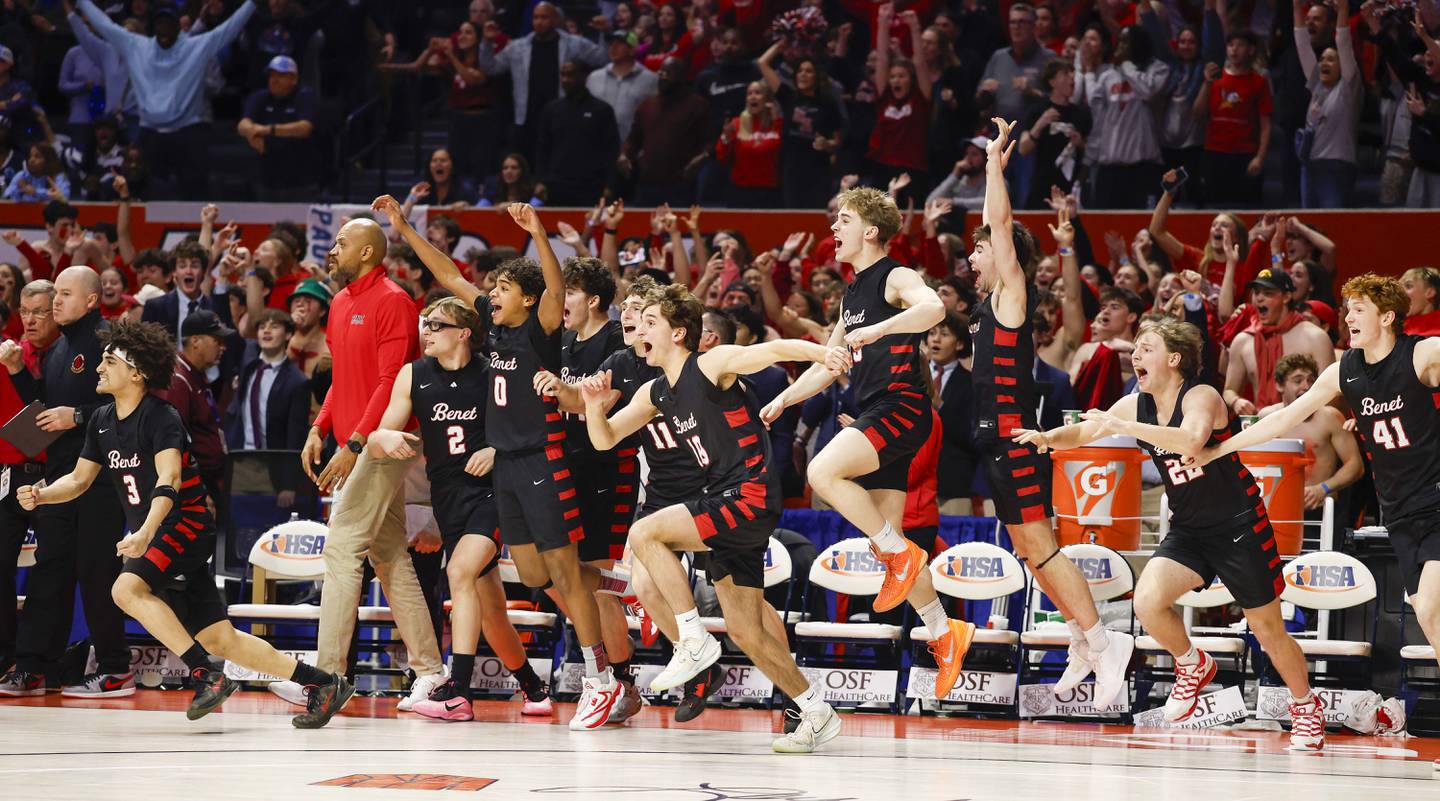 The Benet bench explodes as they advance over DePaul College Prep in the IHSA Class 4A boys basketball state semifinal Friday, March 13, 2026 at the State Farm Center in Champaign.