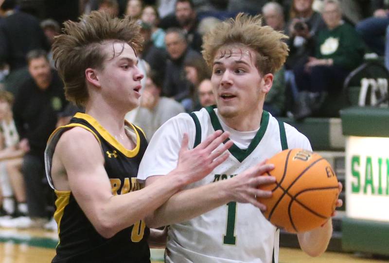 St. Bede's Kaden Newman looks to pass the ball around Ashton-Franklin Center's Aaron Lester during the Class 1A Regional quarterfinal game on Monday, Feb. 24, 2025 at St. Bede Academy.