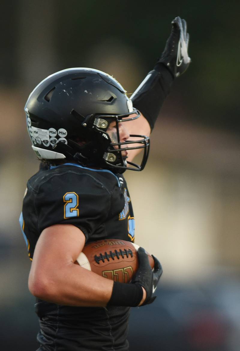 Joe Lewnard/jlewnard@dailyherald.com
Maine West’s Benjamin Cooper points toward the Warriors’ direction of play after intercepting a Schaumburg pass during Friday’s game in Des Plaines.