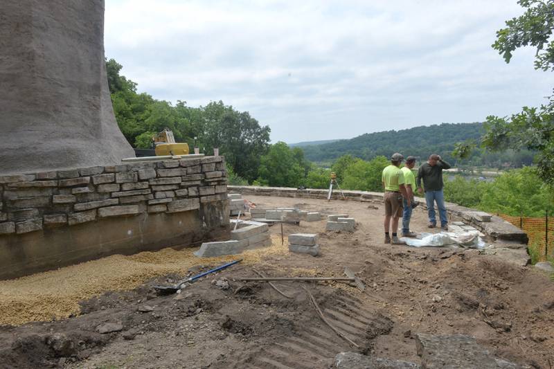 Jake Meyers, Matt Ewald, and Troy O'Brien of O'Brien Civil Works, Inc. of Mt. Morris examine some of the large stones as they work around the base of the Black Hawk Statue at Lowden State Park in June 2023. The work was being done to create a new plaza area around the historic statue that was restored two years ago following a multi-year effort.