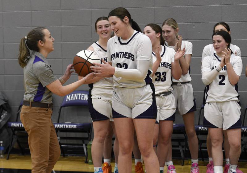 Manteno's Maddie Gesky accepts a ball from head coach Bethany Stritar, left, after becoming the school's all-time leading scorer in a game against Herscher on Thursday, January 15, 2026.