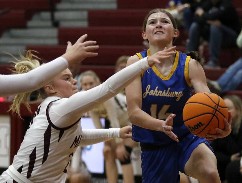 Johnsburg's Summer Toussaint drives to the basket against Marengo's Mia Feidt during a Kishwaukee River Conference basketball game on Saturday, Feb. 1, 2025, at Marengo High School.