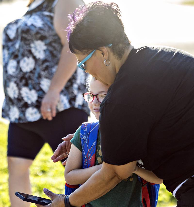Mary Worley hugs granddaughter Bryar Miles, as the first grader goes into Jefferson School Thursday, August 14, 2025, for the first day of Sterling’s schools.