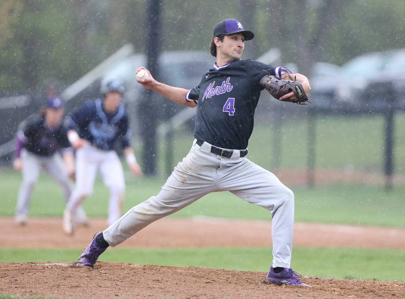 Downers Grove North's Joseph Chiarelli (4) pitches in the rain during the varsity baseball game between Downers Grove South and Downers Grove North in Downers Grove on Saturday, April 29, 2023.