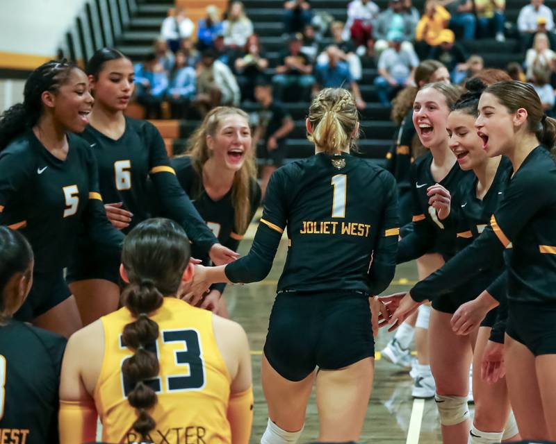 Joliet West's Ava Grevengoed (1) is greeted by teammates during pregame introductions before their regional final volleyball match versus Bolingbrook.  Oct 26, 2023.
