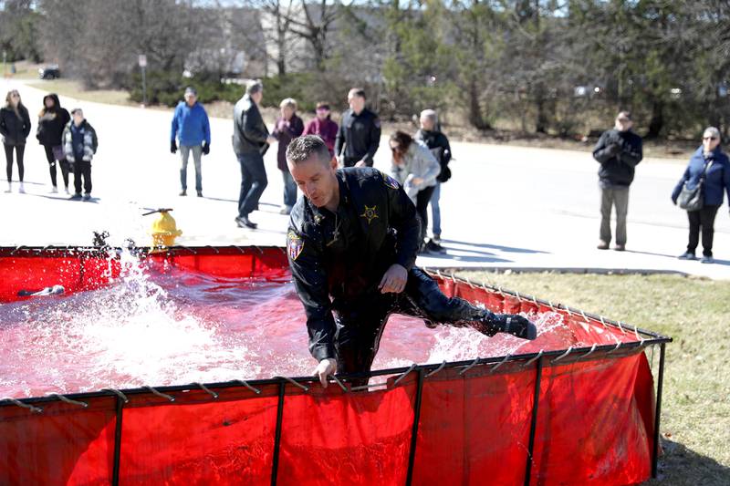 Wheaton Police Deputy Chief Brian Gabryel climbs out of the pool after taking the plunge during the Wheaton Police Department’s annual polar plunge to benefit Illinois Special Olympics on Saturday, March 22, 2025 at the Wheaton Fire Department.