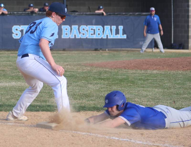 Newman's Silas Baeza slides safely back to first base as Bureau Valley's Reid Maynard catches the late throw on Monday, March 30, 2026 at Bureau Valley High School.