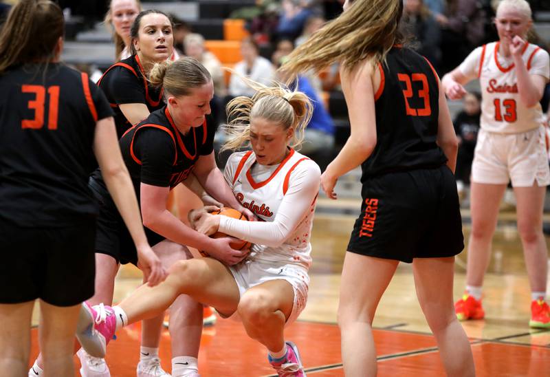 Wheaton Warrenville South's Mckenna Bloodworth and St. Charles East's Alyse Price battle for a jump ball during a game on Tuesday, Feb. 11, 2025 in St. Charles.