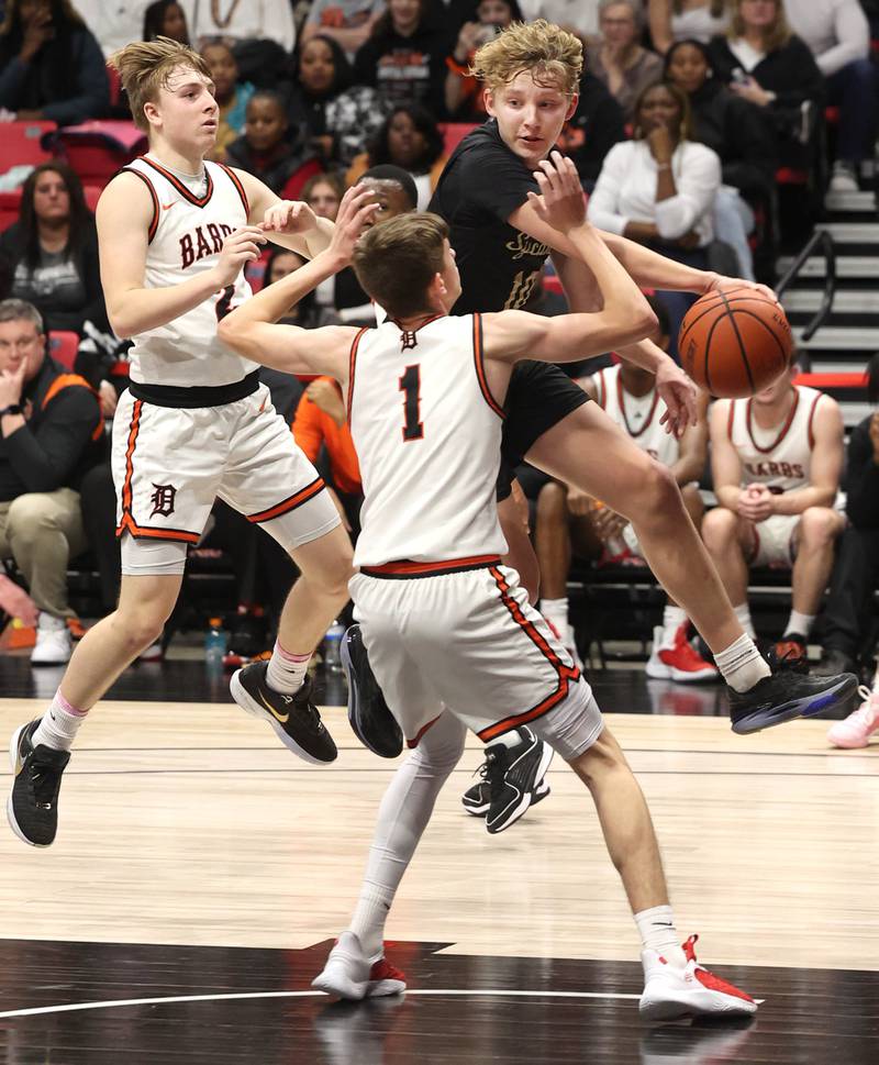 Sycamore's Isaiah Feuerbach passes around DeKalb’s Jackson Kees Friday, Jan. 26, 2024, during the FNBO Challenge in the Convocation Center at Northern Illinois University.