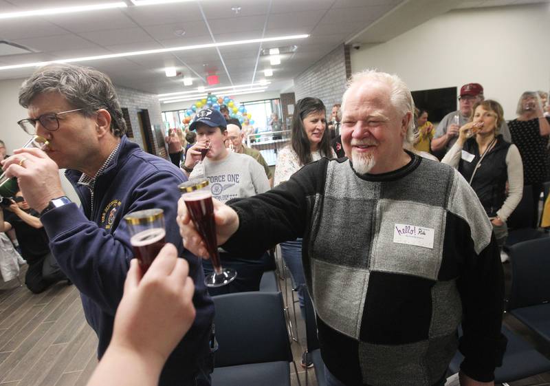Robert Altman, of Antioch enjoys a sparkling juice toast with other patrons Saturday, May 13, 2023, to celebrate the 101st anniversary and the renovation and expansion of the library during the Antioch Public Library District Open House! Ceremony in Antioch.