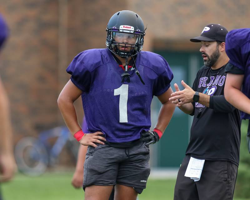 Armando Martinez receives instructions during offensive drills at Plano High School football practice.  August 9, 2023.