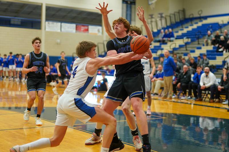 Geneva’s Brady Kafka (4) strips the ball away from St. Charles North's Jake Furtney (33) during a basketball game at Geneva High School on Wednesday, Feb 14, 2024.