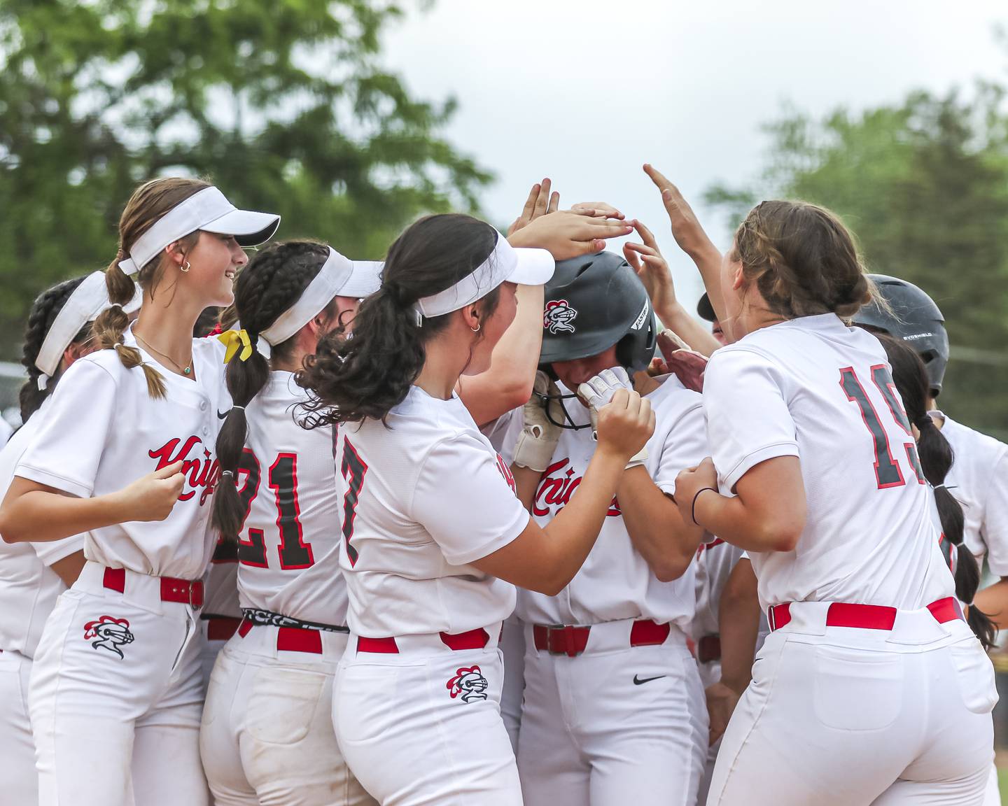 Lincoln-Way Central's Teagan Berkshire (9) is mobbed at the plate after hitting a homerun during Class 4A Lockport sectional softball game between Lincoln-Way Central at Lincoln-Way West on Tuesday, June 3, 2025 in Lockport.