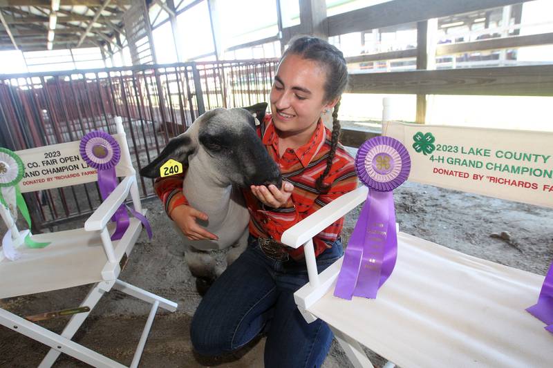 Isabella Zimmer, 17, of Glenview, shows off her Grand Champion market lamb, named Gallo, and his ribbons during the Lake County Fair at the Lake County Fairgrounds on Saturday, July 29, 2023, in Grayslake.