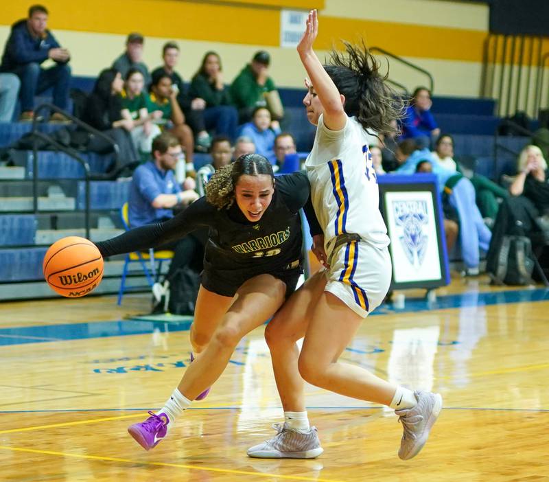 Waubonsie Valley's Danyella Mporokoso (10) drives to the hoop against Aurora Central Catholic's Sofia Corral (33) during a basketball game at Aurora Central Catholic High School on Thursday, January 30, 2025.