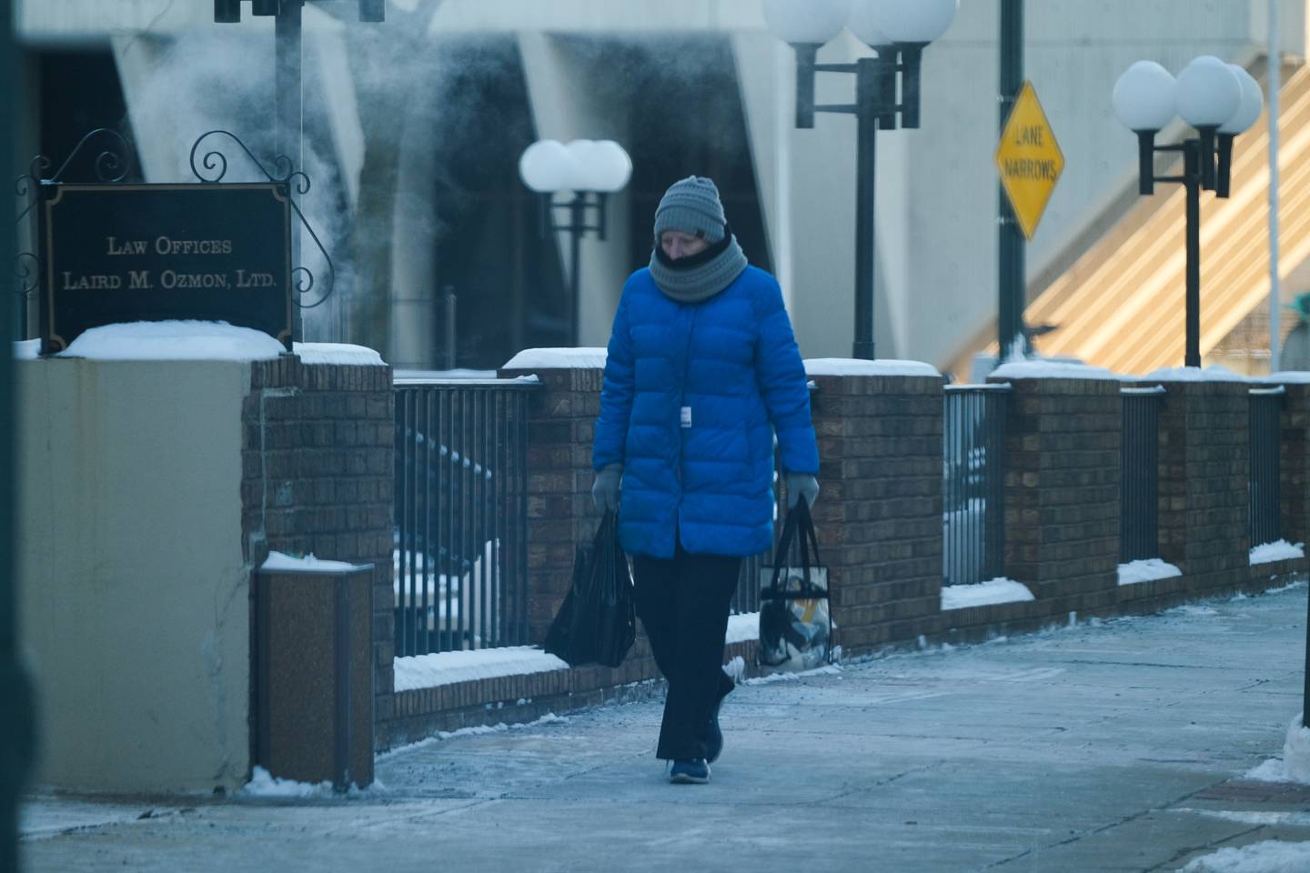 A bundled up pedestrian walks along North Joliet Street in downtown Joliet. Subzero temperatures only made it to the low teens on a bitter cold Wednesday. Wednesday, Jan. 26, 2022 in Joliet.