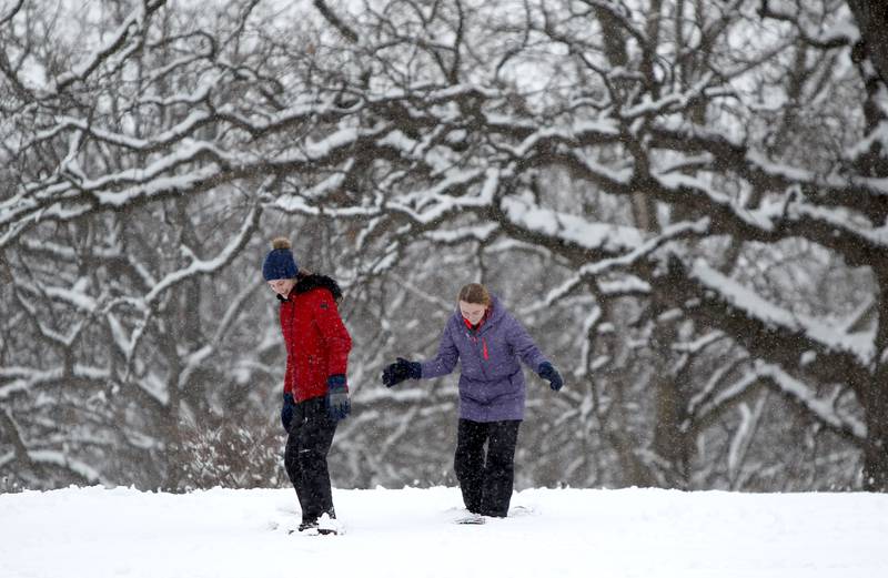 Sisters Delaney, 15, (left) and Reese Fields, 13, of Batavia use sleds as snowboards down the hill at Fabyan Forest Preserve in Geneva on Wednesday, Jan. 25, 2023.