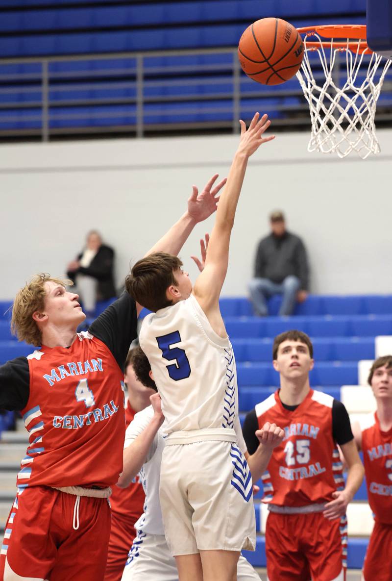Burlington Central's Cash Cumpata gets to the basket ahead of Marian Central's Quinn Brady Monday, Jan. 15, 2023, during their game in the Burlington Central Martin Luther King Jr. boys basketball tournament.
