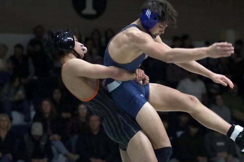 Crystal Lake Central’s Abe Pabmino throws Cary-Grove’s Jacob Turner at 138 pounds in varsity wrestling Thursday, Dec. 19, 2024 at Cary-Grove High School in Cary.