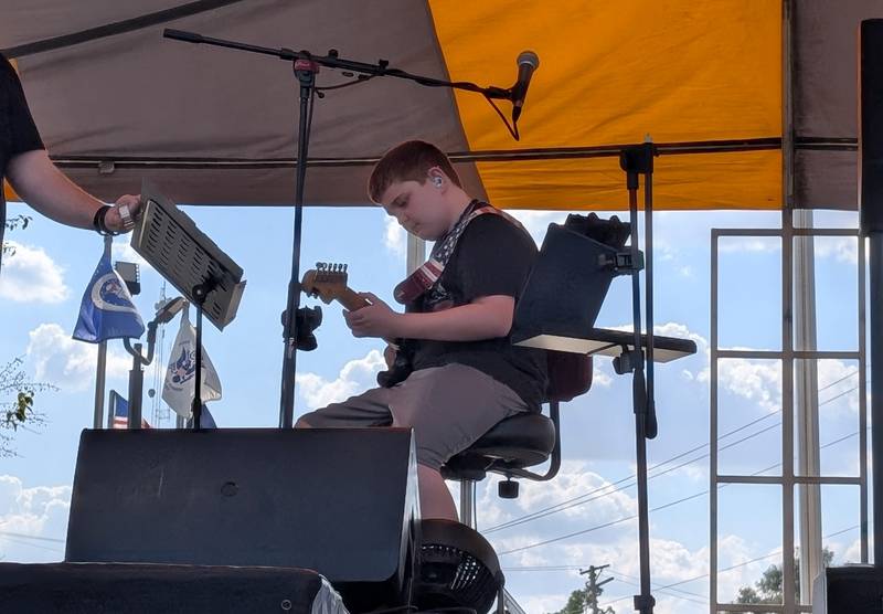 Jesse Childress, 12, of St. Anne, performs ‘The Star Spangled Banner’ on his guitar during the St. Anne Pumpkin Festival on Saturday, Oct. 4, 2025.