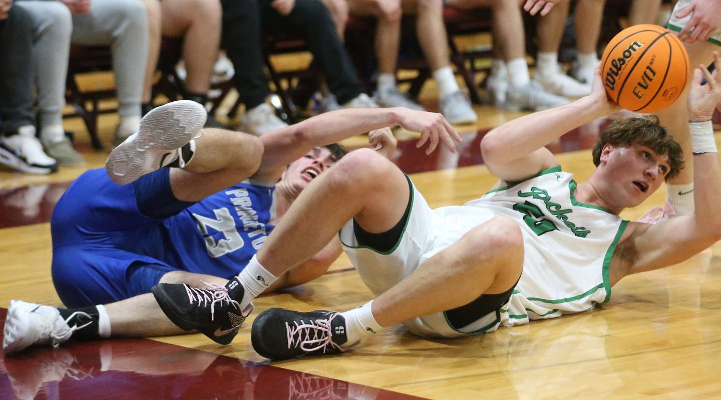 Rock Falls's Cole Mulnix grabs a loose ball over Princeton's Noah LaPorte during the Class 2A Sectional final on Friday, March 7, 2025 at Marengo High School.