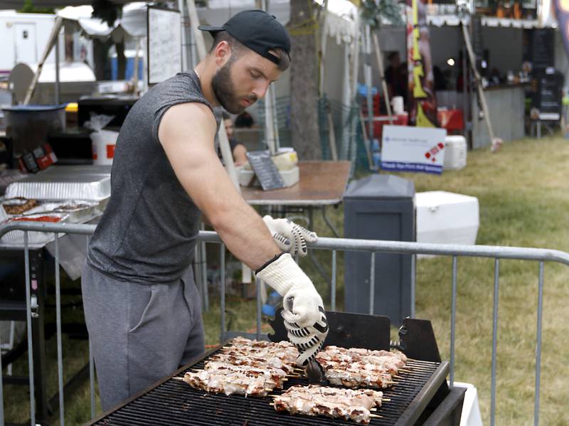 Marc Karman, of Victors’s Grill, cooks pork kabobs during Lakeside Festival Friday, June 30, 2023, at the Dole and Lakeside Arts Park in Crystal Lake.