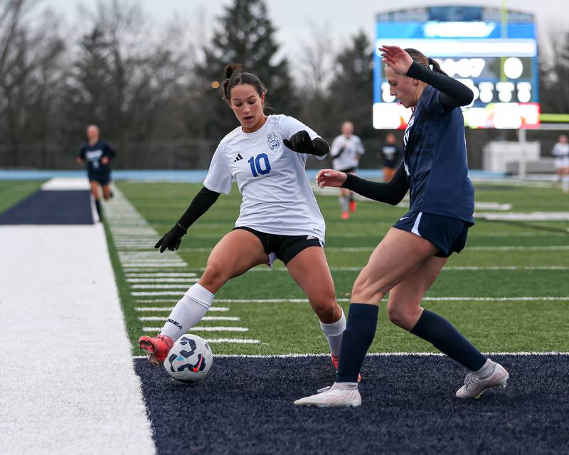 Riverside-Brookfield's Ella Caputo (10) is defended by Downers Grove South's Megan Pogorelec (4) during soccer match between Riverside-Brookfield at Downers Grove South.  April 10, 2025.