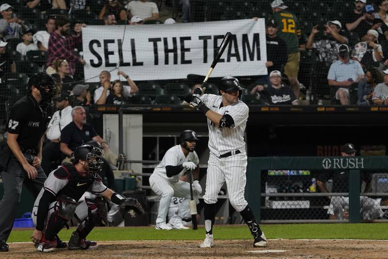 Chicago White Sox's AJ Pollock (18) bats against the Arizona Diamondbacks as fans hold a sign during the ninth inning of a baseball game, Saturday, Aug. 27, 2022, in Chicago. (AP Photo/David Banks)