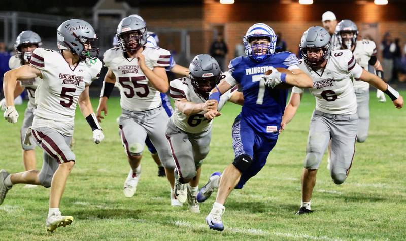 Princeton quarterback Gavin Lanham tries to stay ahead of the crowd of Rockridge defenders Friday night at Bryant Field. The Rockets won 36-29.