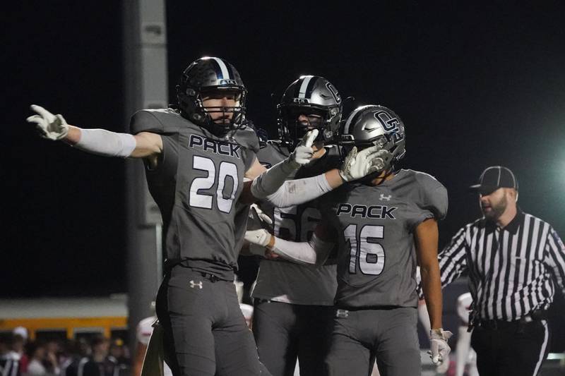 Oswego East's Andrew Pohlman (20) celebrates with his team mates after scoring a touchdown against Oswego during a football game at Oswego East High School on Friday, October 25, 2024.