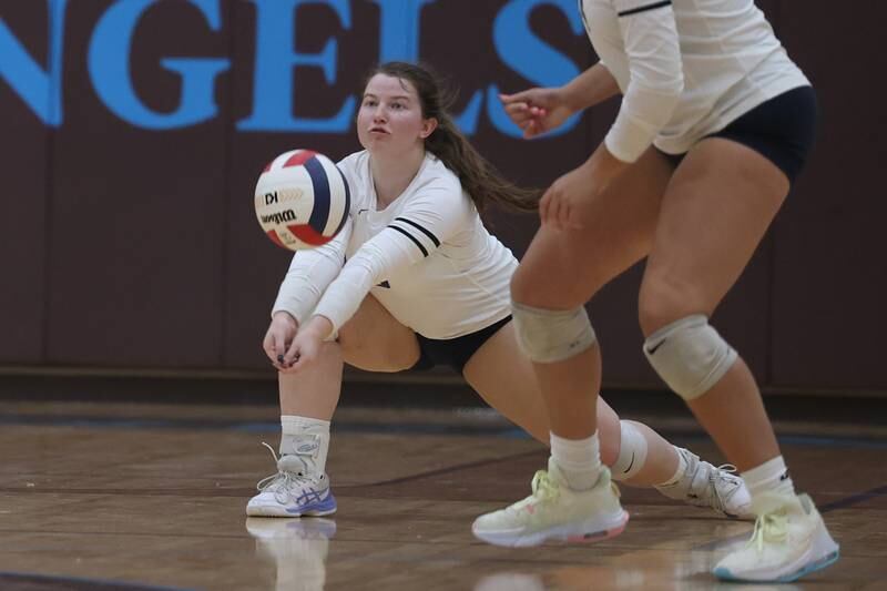 Nazareth’s Megan McNicholas digs out a serve against Joliet Catholic on Tuesday, October 11th in Joliet.